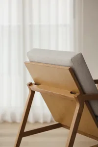 A modern oak chair with upholstered seat and backrest, featuring clean lines and a simple design.