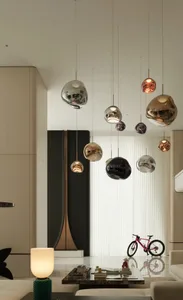 Modern living room featuring metallic glass pendant lights and minimalist furniture