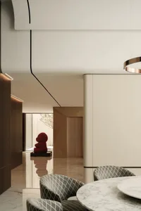 Modern minimalist dining room with marble floor and furniture, featuring geometric patterns and a red sculpture.