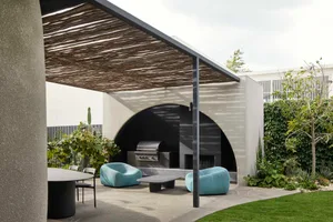 A modern outdoor space featuring concrete and metal structures, designed for relaxation and entertainment.