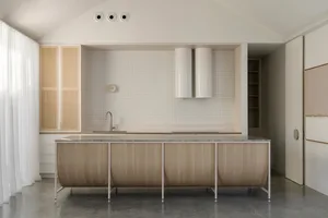 Minimalist kitchen with clean lines, white walls, and glass walls.