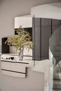 Modern kitchen with marble countertops and white cabinets