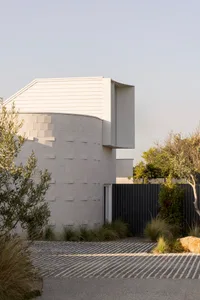 Modern residential building exterior with concrete and wooden elements