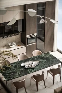 A modern residential kitchen featuring a marble countertop, wooden cabinets, and glass elements.
