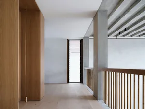 Minimalist interior space featuring wood and concrete elements.