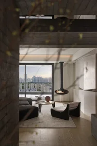 Modern concrete living room with a suspended fireplace, large windows, and minimalist furniture.