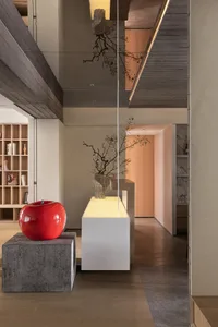 Modern residential entryway featuring concrete, wood, and glass materials
