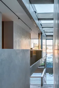 Contemporary interior space with modern design elements including concrete walls and glass elements.