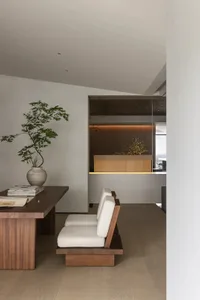 A modern living room with wooden furniture and minimalist decor.