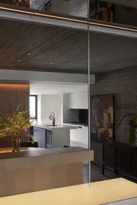 Modern kitchen with wooden island, metal accents, and glass surfaces.
