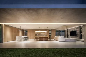 A modern living room with a wooden floor, walls, and furniture.