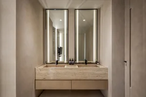 Modern bathroom with sleek marble countertops and twin sinks.