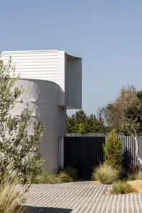 Modern residential architecture featuring concrete elements and outdoor spaces.