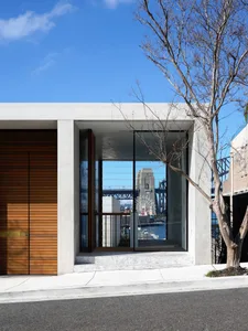 Modern entrance with concrete materials and large glass panels.