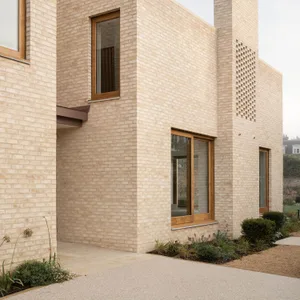 The exterior of a modern house with brick cladding.