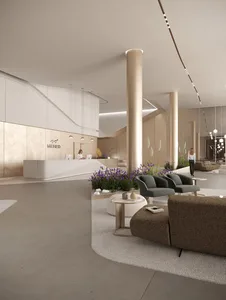 A modern office reception area with concrete walls and flooring, metal accents, and glass partitions.