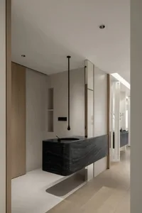 A modern, minimalist bathroom featuring black metal fixtures and a sleek, contemporary design.