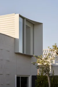 Modern building with concrete exterior and large window.