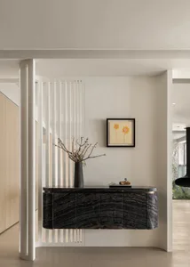 Contemporary entrance area featuring marble furniture and minimalistic design.