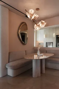 Modern living room featuring a circular wooden table and fabric seating area.
