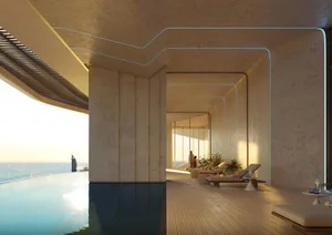 A modern swimming pool deck with a concrete structure and lounge chairs.