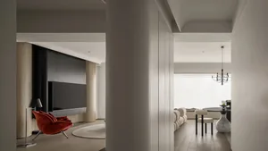 Modern living room with wood floors, metallic fixtures, and contemporary furniture.
