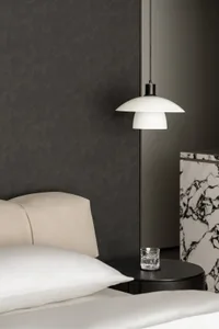 A minimalist bedroom featuring a marble bedside table and a white pendant lamp.