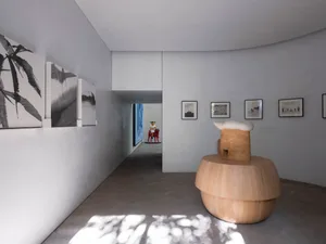 Minimalist art museum interior showcasing black and white pieces on light-colored walls.