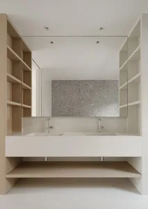 A minimalist modern bathroom with a white floating vanity, concrete countertop, and large mirror.