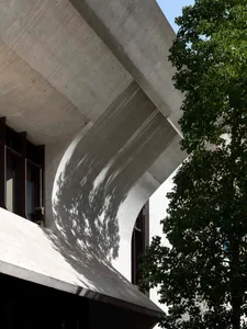 Concrete building exterior with tree shadows