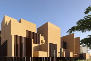 A modern building constructed with sandstone and wood materials.