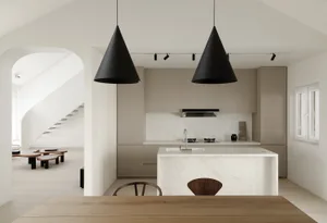 Modern kitchen featuring a marble countertop and stone island with a minimalist design.