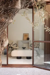 A modern living room featuring glass and marble elements.