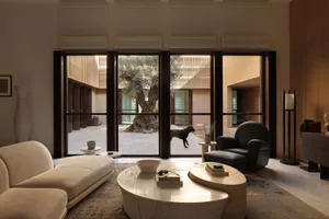 A modern living room featuring marble elements and a large window.