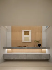 Modern minimalist living room featuring a stone platform with a minimalist abstract painting, minimalistic decor, and a sleek
