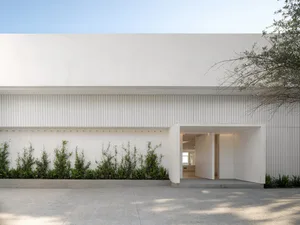 Modern building exterior featuring minimalistic design and use of concrete.