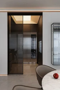 Modern kitchen featuring glass panels on a refrigerator and cabinets.