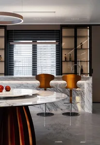 A modern kitchen features marble countertops and a sleek, contemporary design.