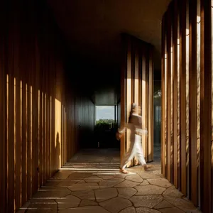 A minimalist interior with stone wall and floor.