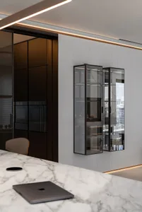 A modern kitchen featuring glass cabinets and a marble countertop.
