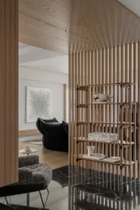 Modern living room interior featuring an elegant wooden divider with a minimalist design, featuring decorative items and a co