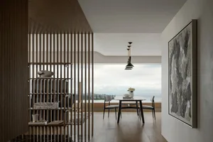 Modern interior design featuring a marble coffee table and gray sofas.