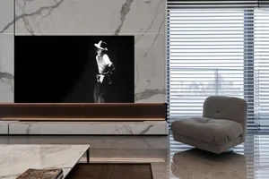 Modern living room featuring marble walls and furniture, with a large window showing a cityscape.