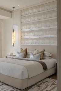 A modern bedroom with a fabric-textured headboard and a pendant light hanging above the bed.