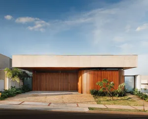 A modern house featuring concrete and wood materials, with a clean, minimalist exterior design.