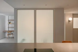 Minimalist modern kitchen with concrete flooring and walls.