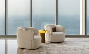 Circular fabric seating with a glass side table in a modern lounge setting.