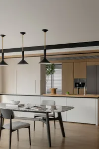A sleek, modern kitchen featuring a marble countertop and wooden cabinetry.