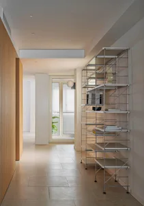 Modern interior design featuring a metal shelving unit with books and decorative items.
