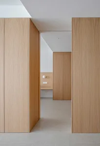 A modern interior design featuring wooden paneling and minimalist furniture.